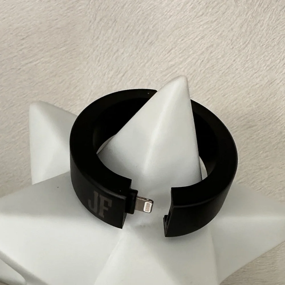 Black Charging Bracelet with JF initials on it.